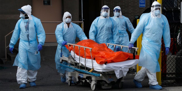 Healthcare workers carry the deceased person's body from Wyckoff Heights Medical Center during the coronavirus disease (COVID-19) outbreak in the Brooklyn neighborhood of New York City, New York, USA, April 2, 2020. 